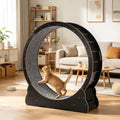 Orange tabby cat running inside a black wooden cat exercise wheel in a living room