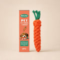 Orange carrot-shaped dog chew toy with retail packaging