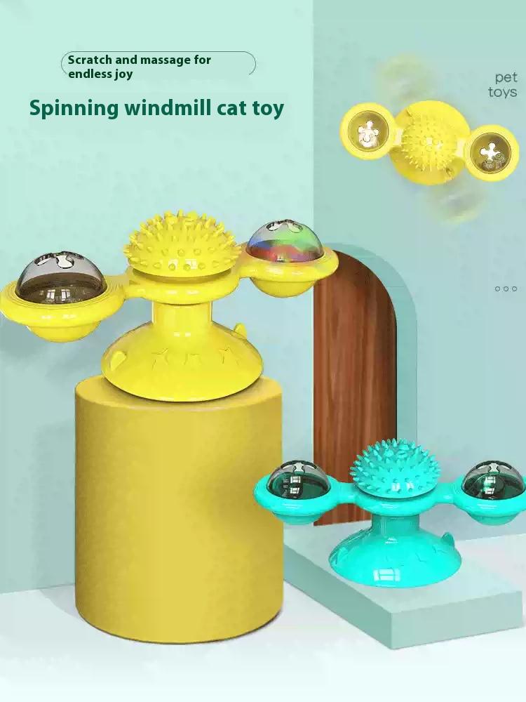 Product card for the spinning windmill cat toy in yellow and turquoise with spiky massage ball and ball domes, captioned for scratch and massage play.