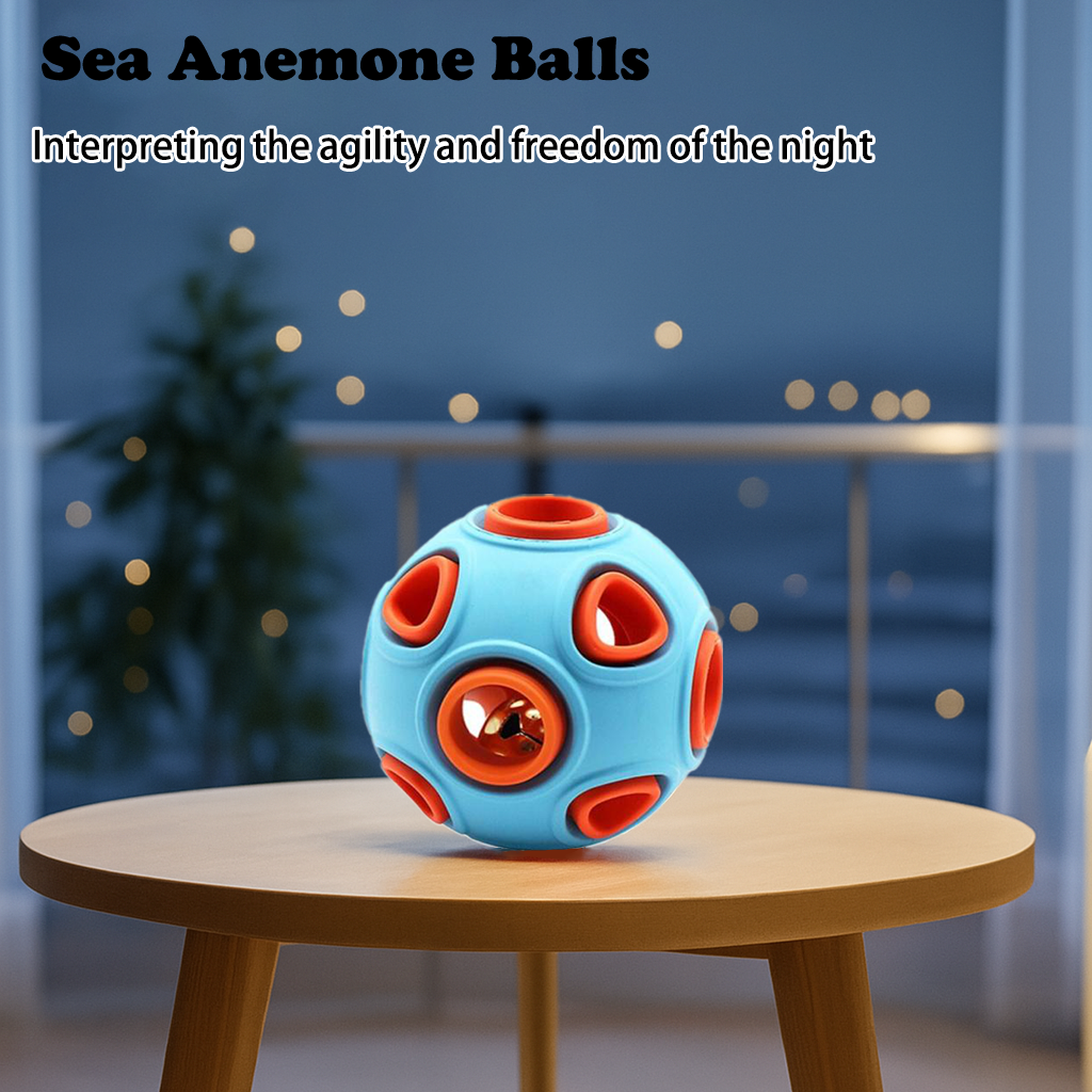 Blue and orange sea anemone rubber ball on a wooden table at night