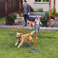 Dog weaving through orange and blue adjustable agility poles
