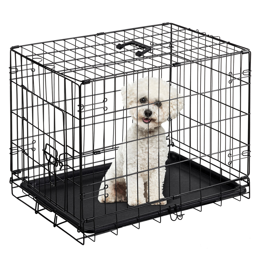 Small white dog sitting inside the black wire dog cage with plastic tray