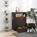 Schnauzer eating from a gray pet feeder station storage cabinet – raised dog bowls in pull-out tray with pet food storage