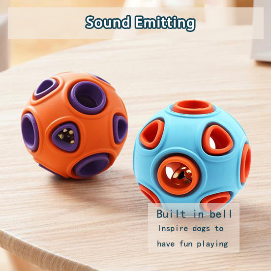 Orange and blue sound-emitting rubber dog balls with built-in bells on a wooden table