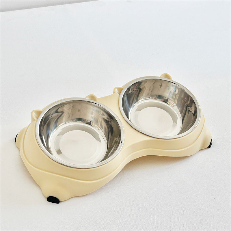 Yellow double macaron stainless steel pet bowl with bone-shaped plastic base, angled view