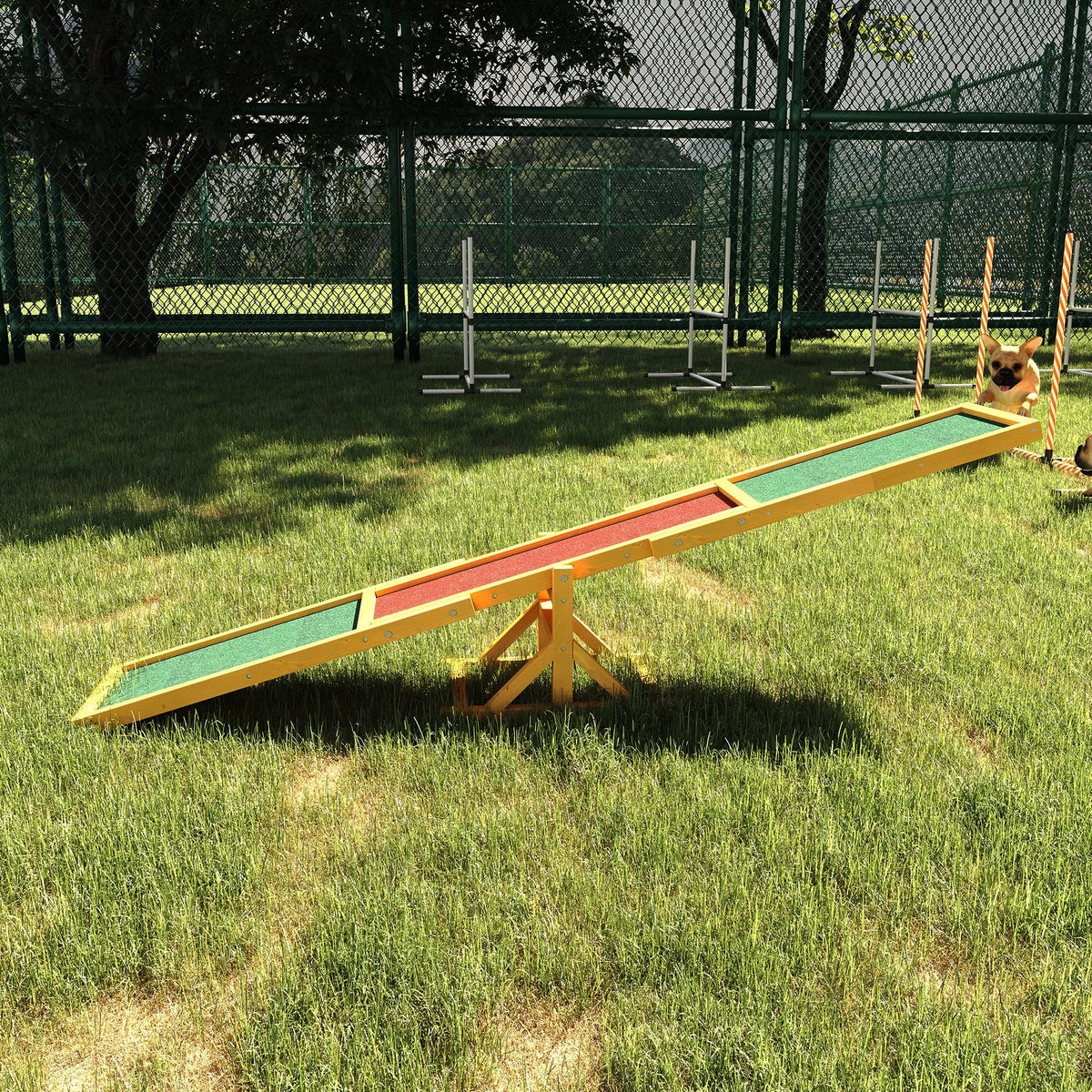 Wooden dog agility seesaw in a grassy yard