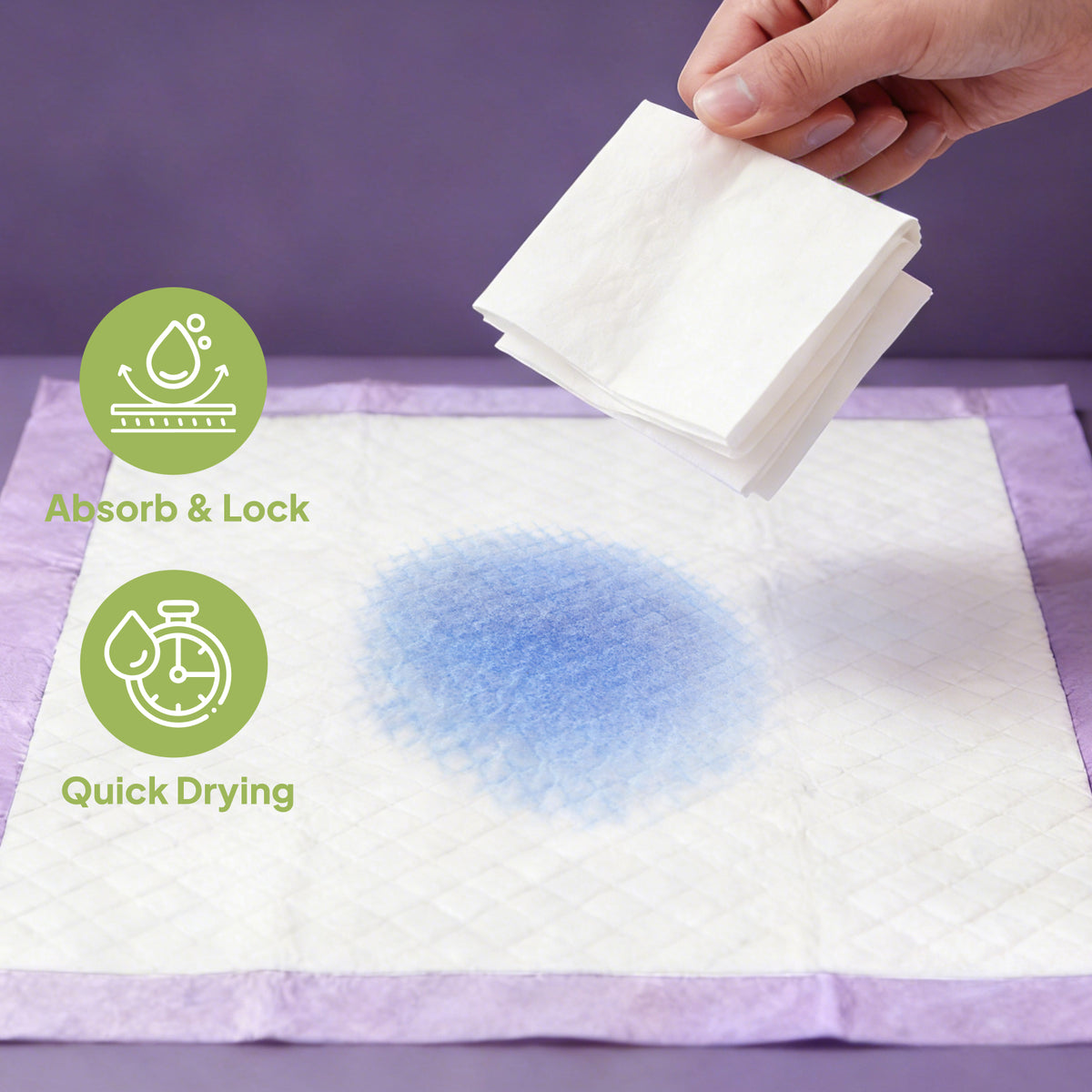 Absorb and lock quick drying demonstration, hand holding folded lavender training pad above pad with absorbed blue liquid