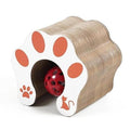 Accordion-style cat scratching post shaped like a cat paw with orange paw print, red ball toy inside the tunnel.